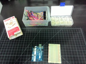 An Arduino Uno, a breadboard, resistors, wires, and LEDs